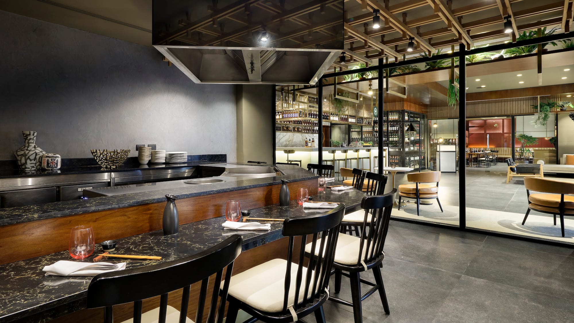 a restaurant with a large counter and chairs