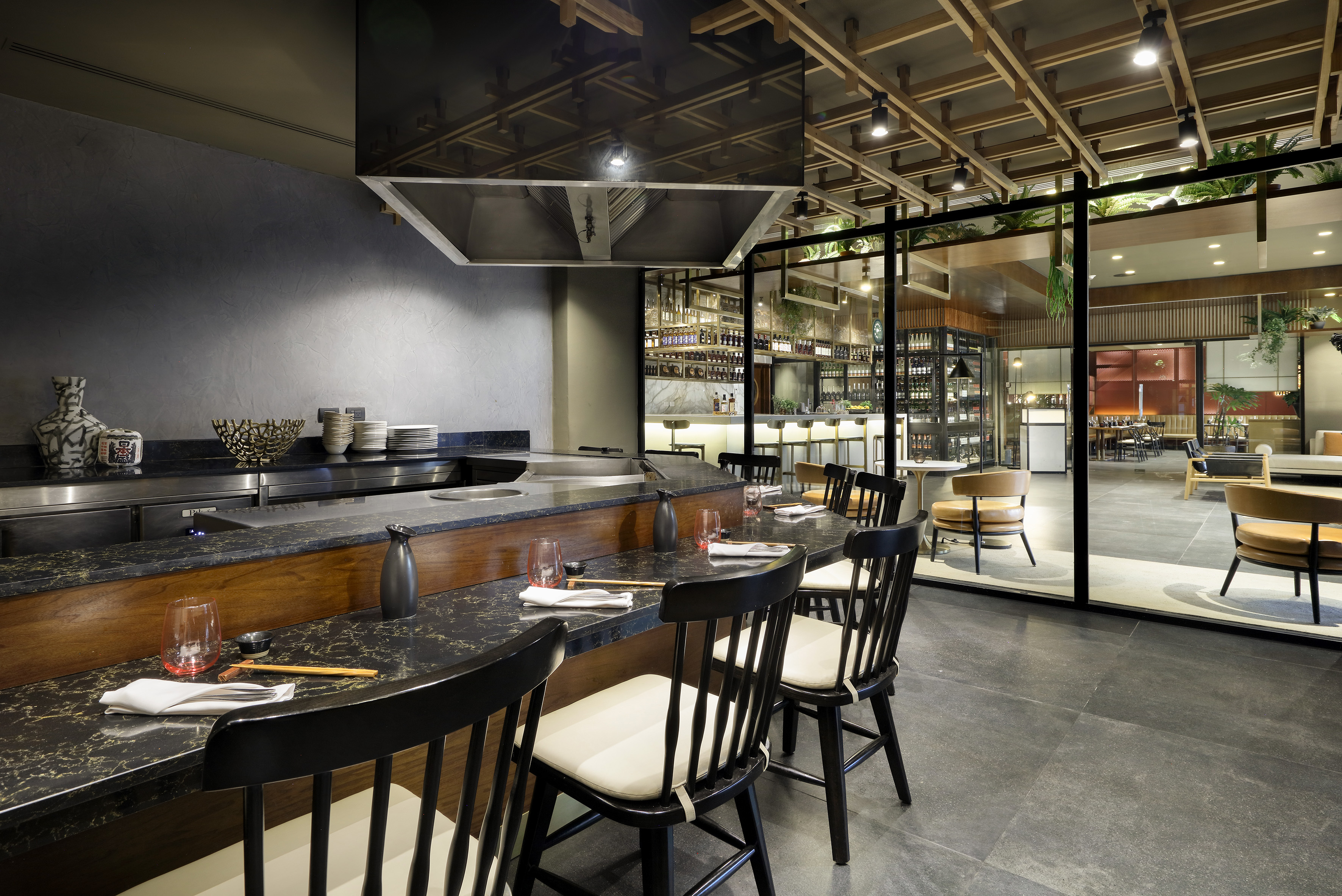 a restaurant with a large counter and chairs