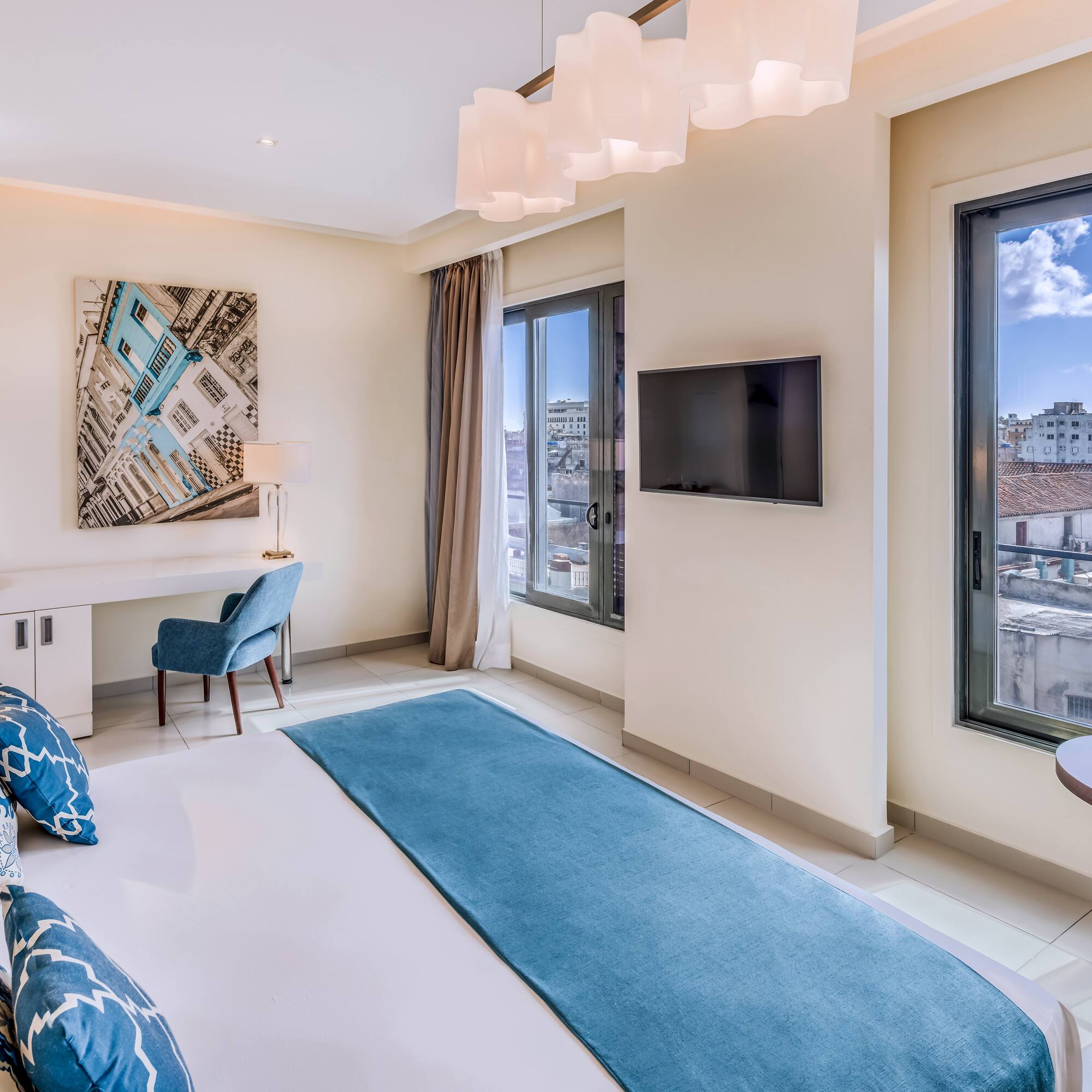 a bedroom with a bed and a television