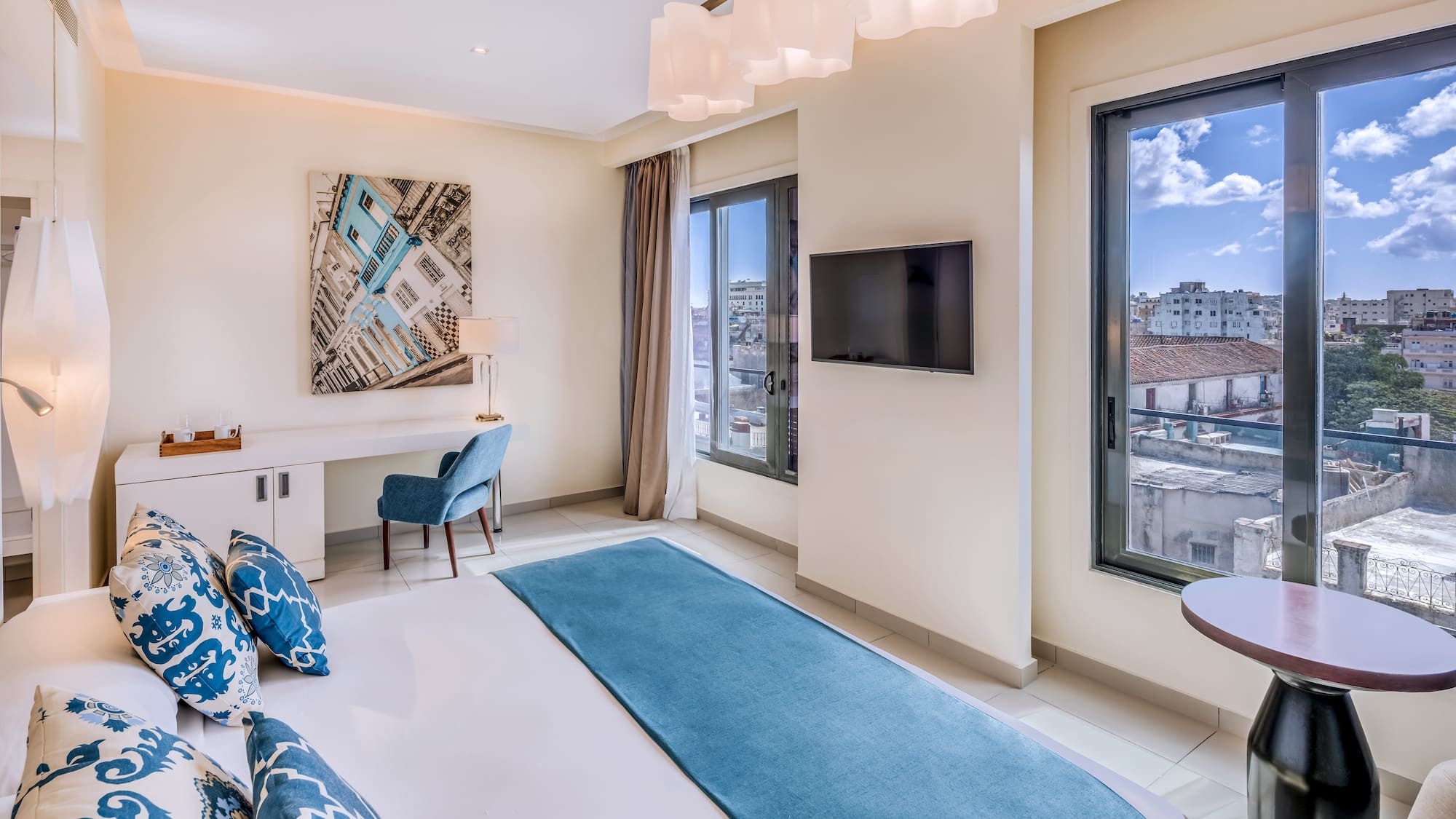 a bedroom with a bed and a television