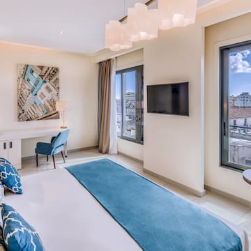 a bedroom with a bed and a television