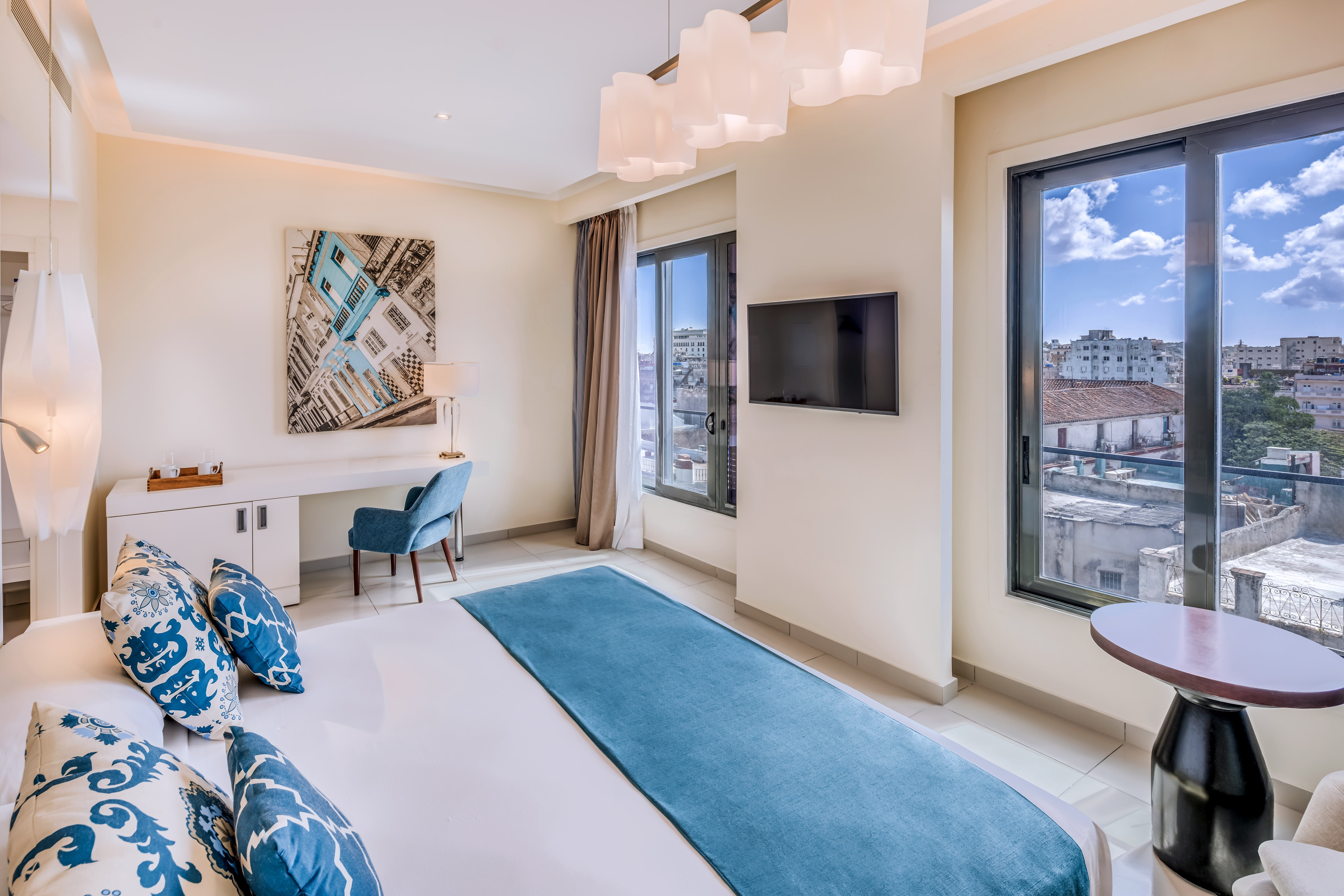 a bedroom with a bed and a television