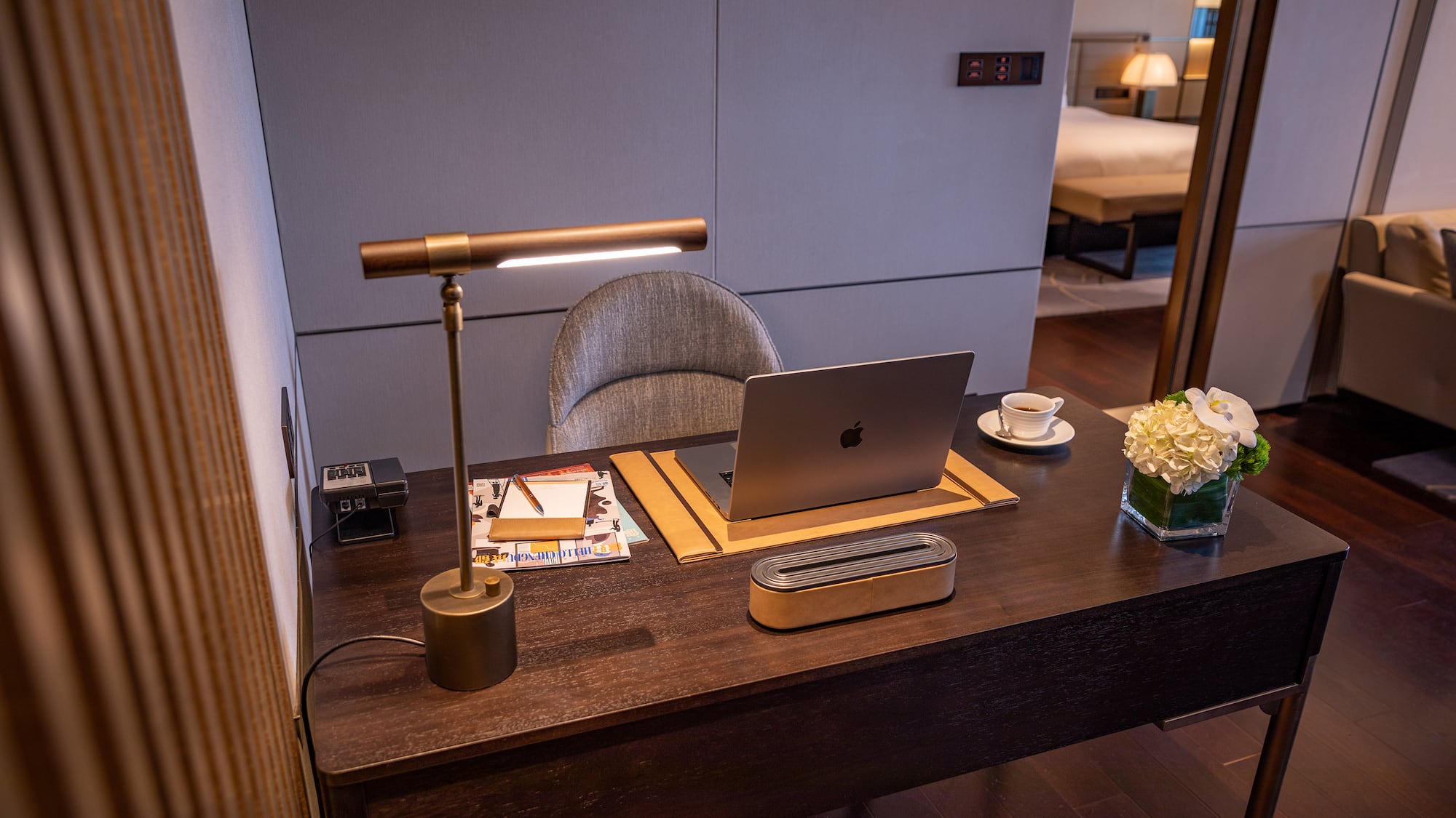 a desk with a laptop and a lamp