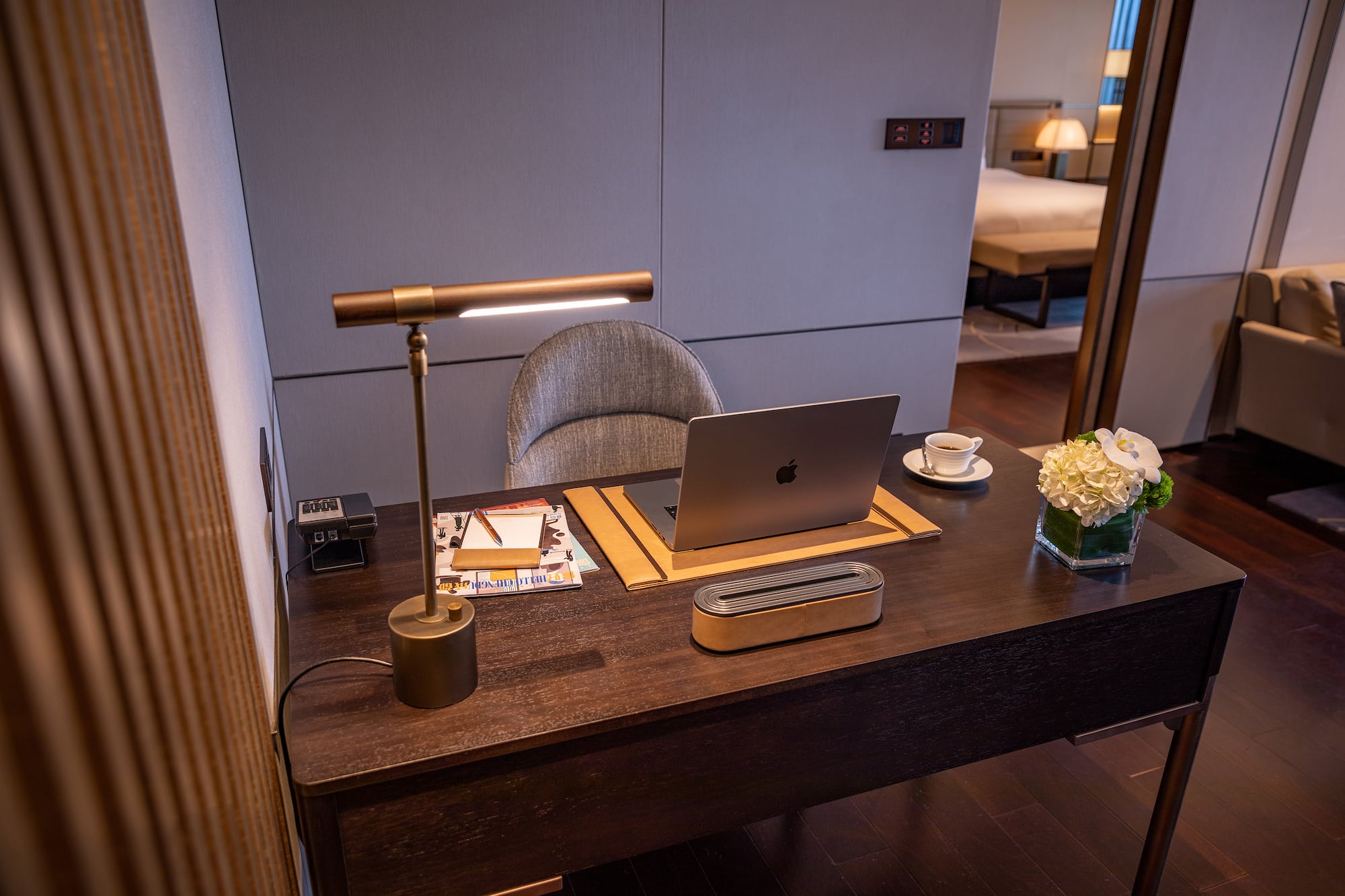 a desk with a laptop and a lamp