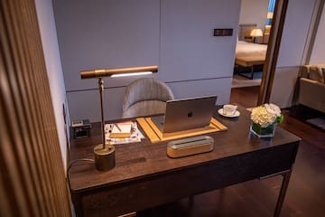 a desk with a laptop and a lamp
