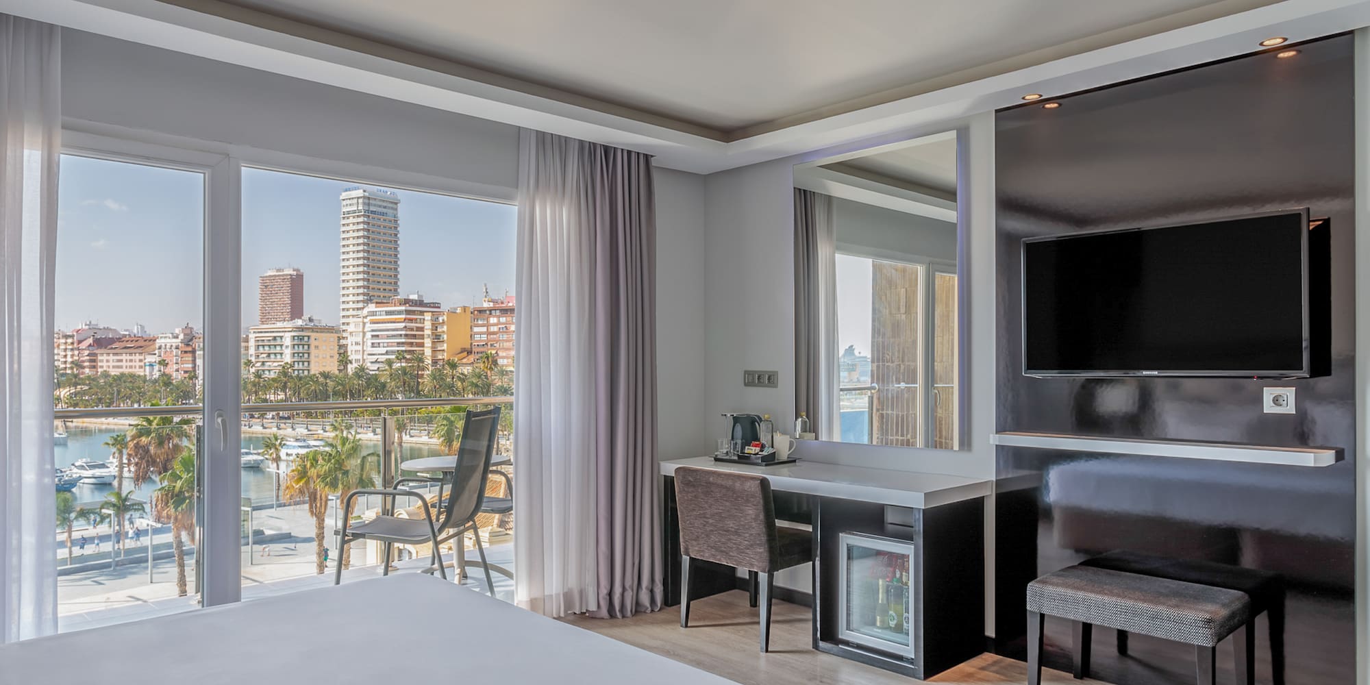 a room with a bed and a television