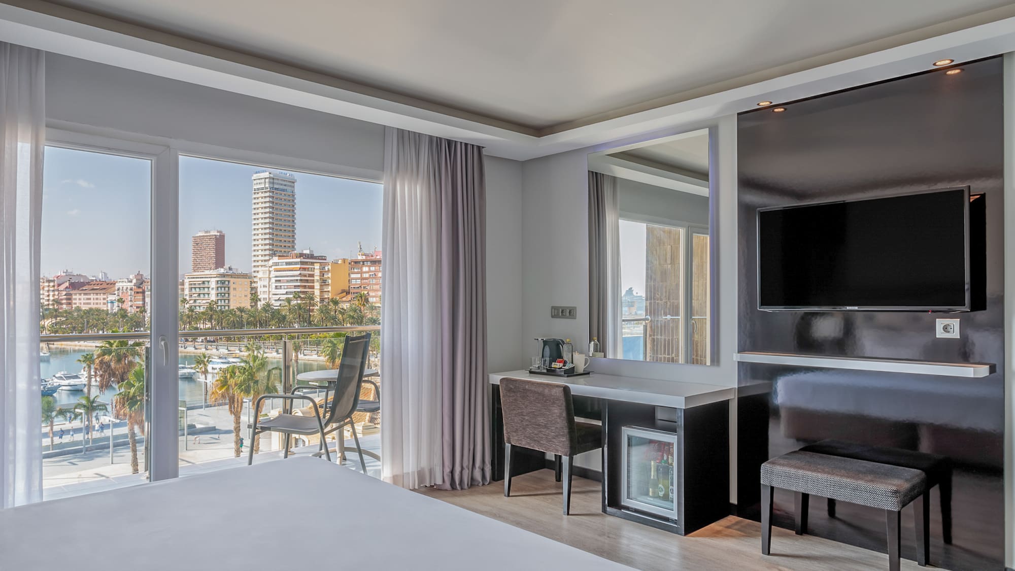 a room with a bed and a television