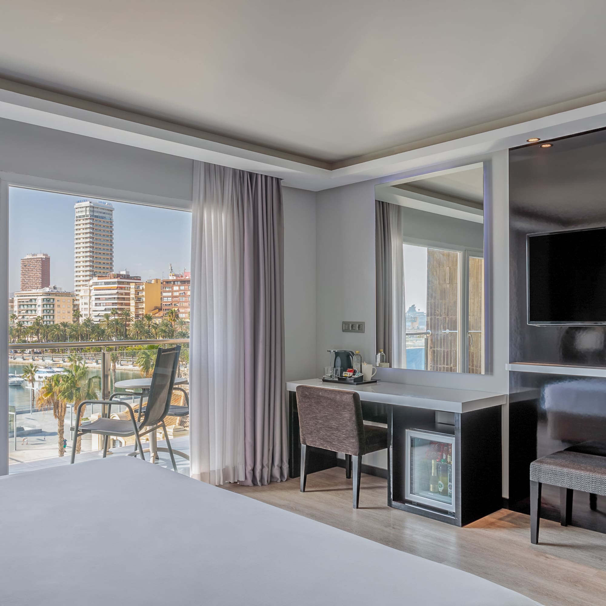 a room with a bed and a television