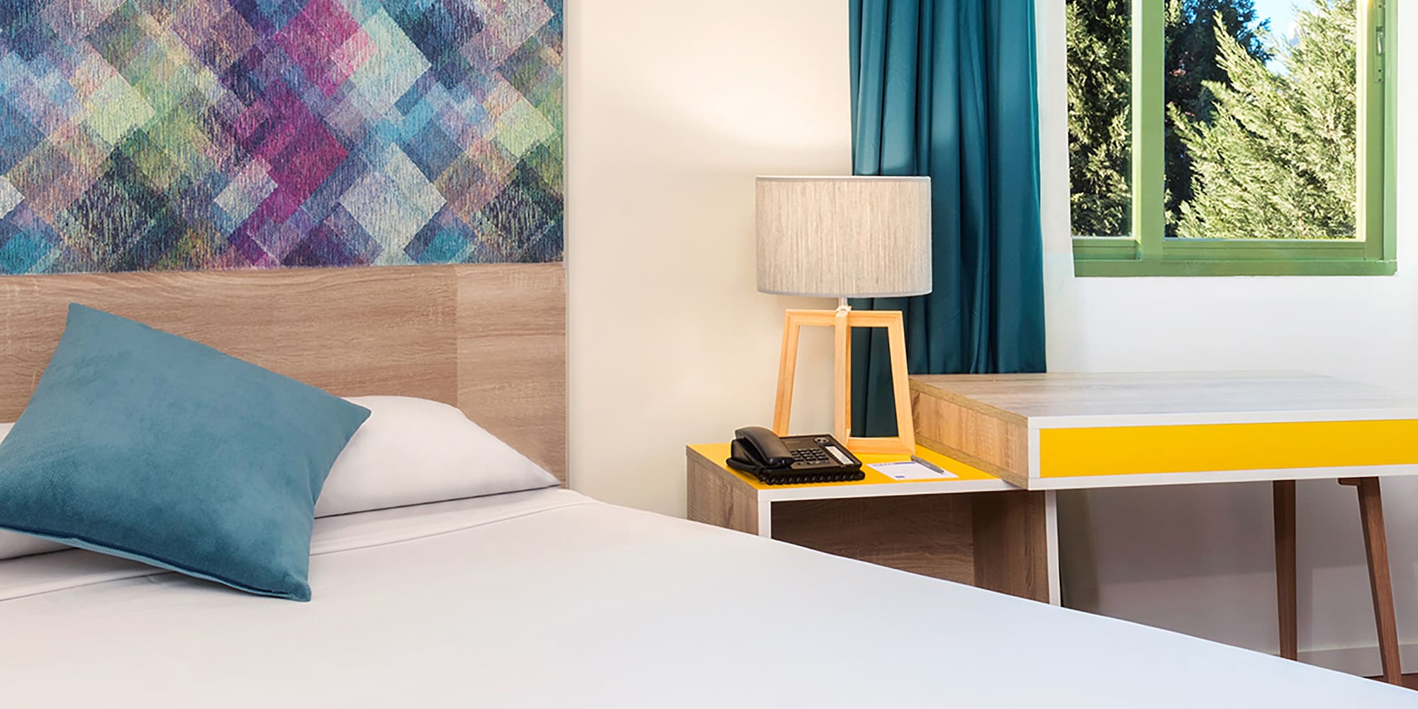 a bed with a pillow and a table in a room