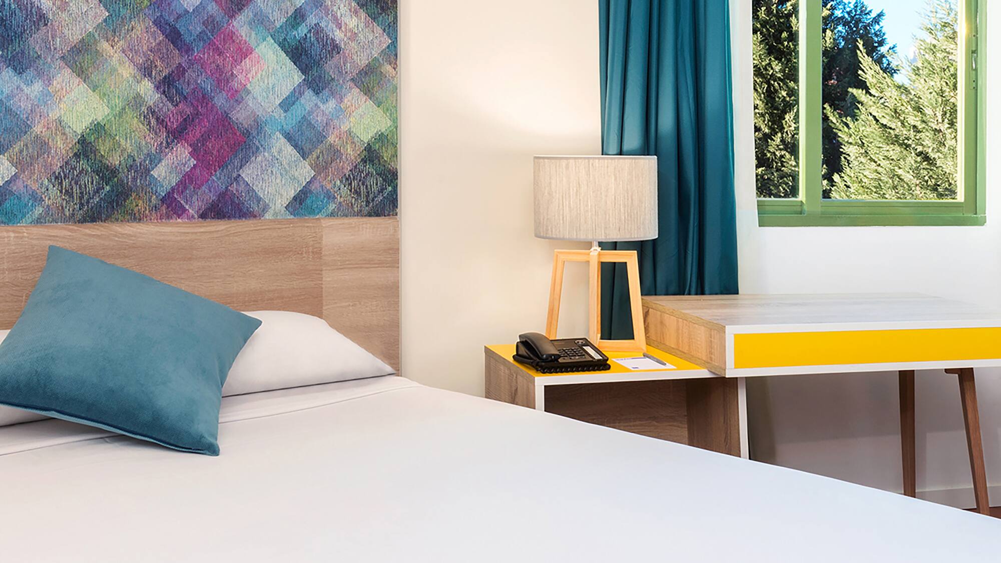 a bed with a pillow and a table in a room