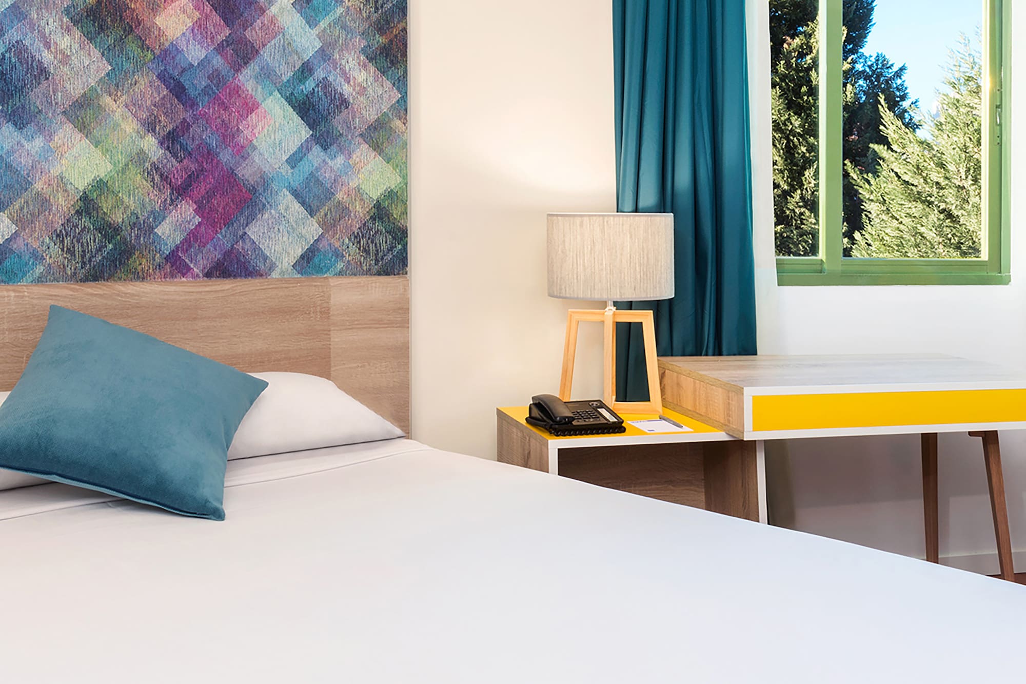 a bed with a pillow and a table in a room