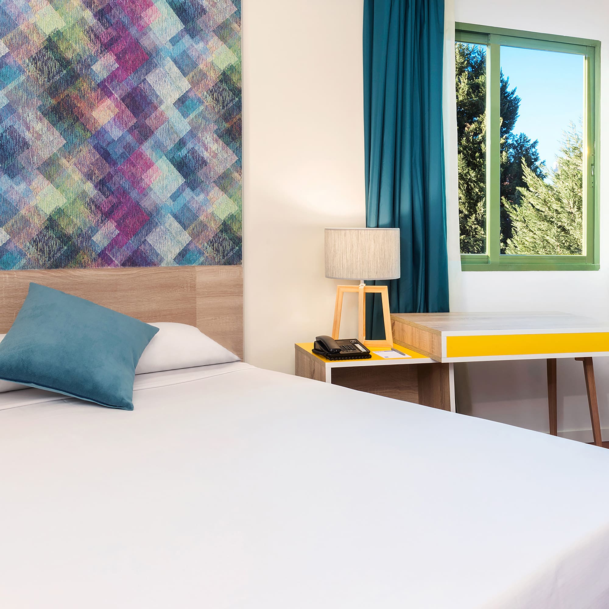 a bed with a pillow and a table in a room