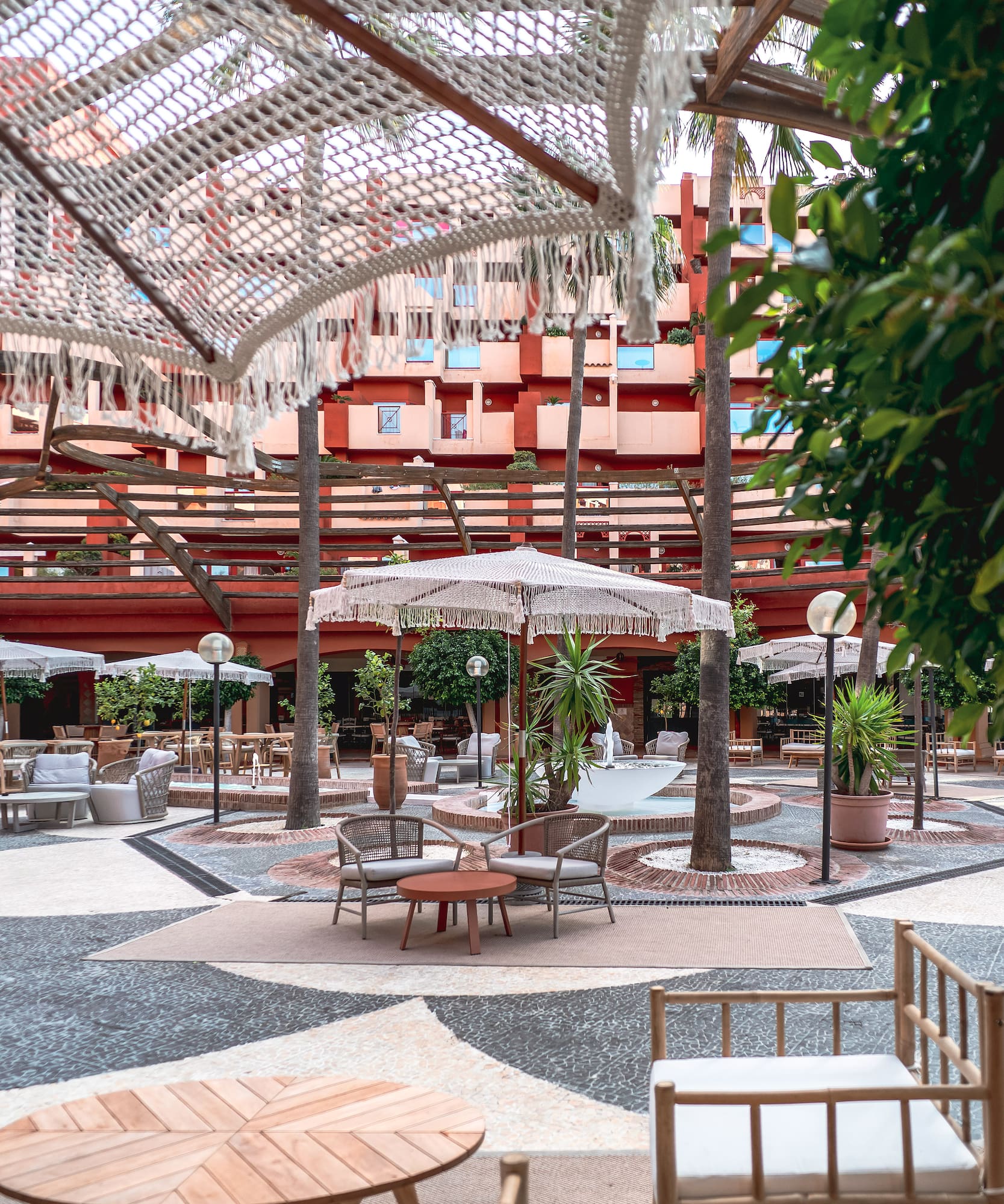 a patio area with chairs and umbrellas