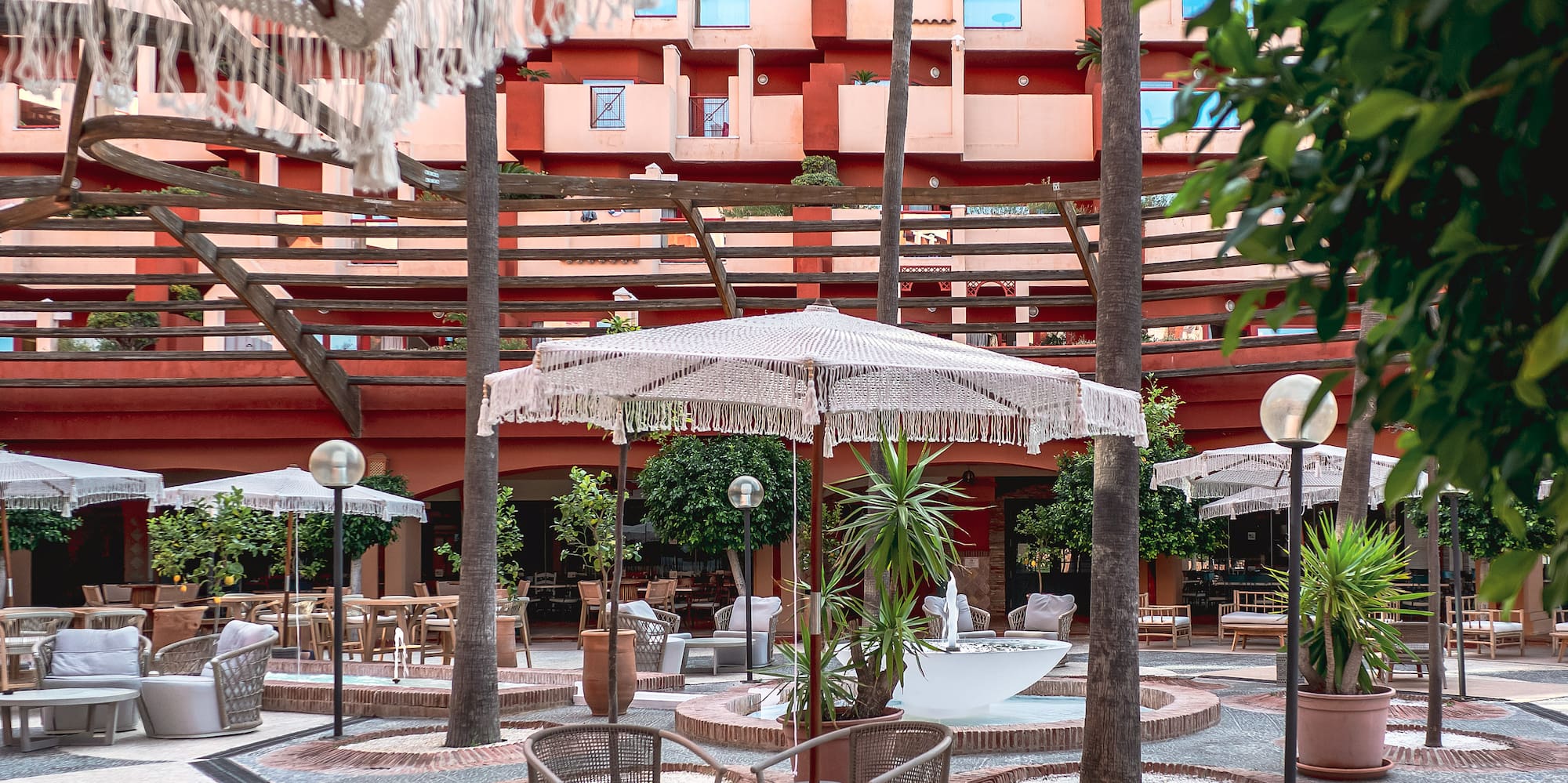 a patio area with chairs and umbrellas