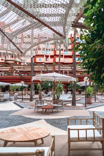 a patio area with chairs and umbrellas
