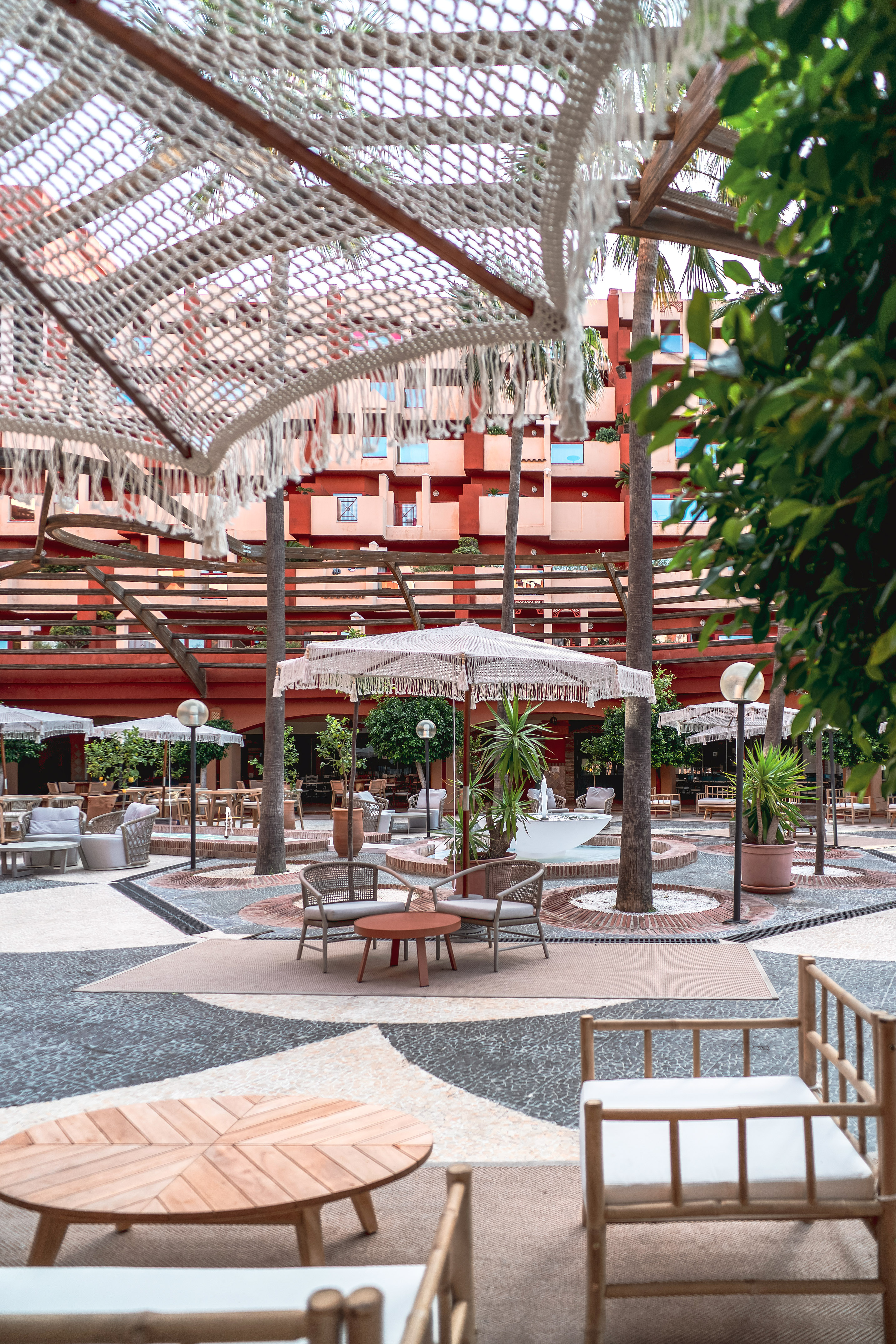 a patio area with chairs and umbrellas