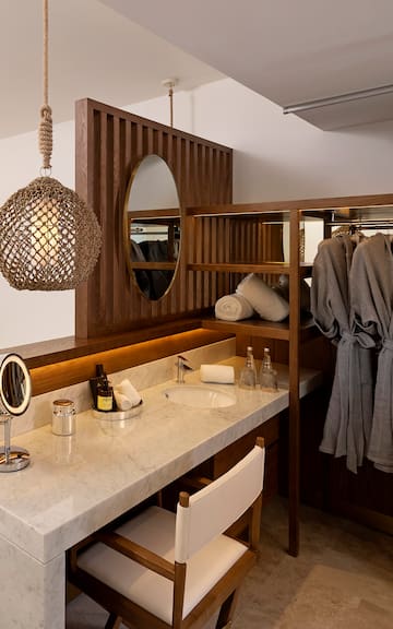 a bathroom with a mirror and towels