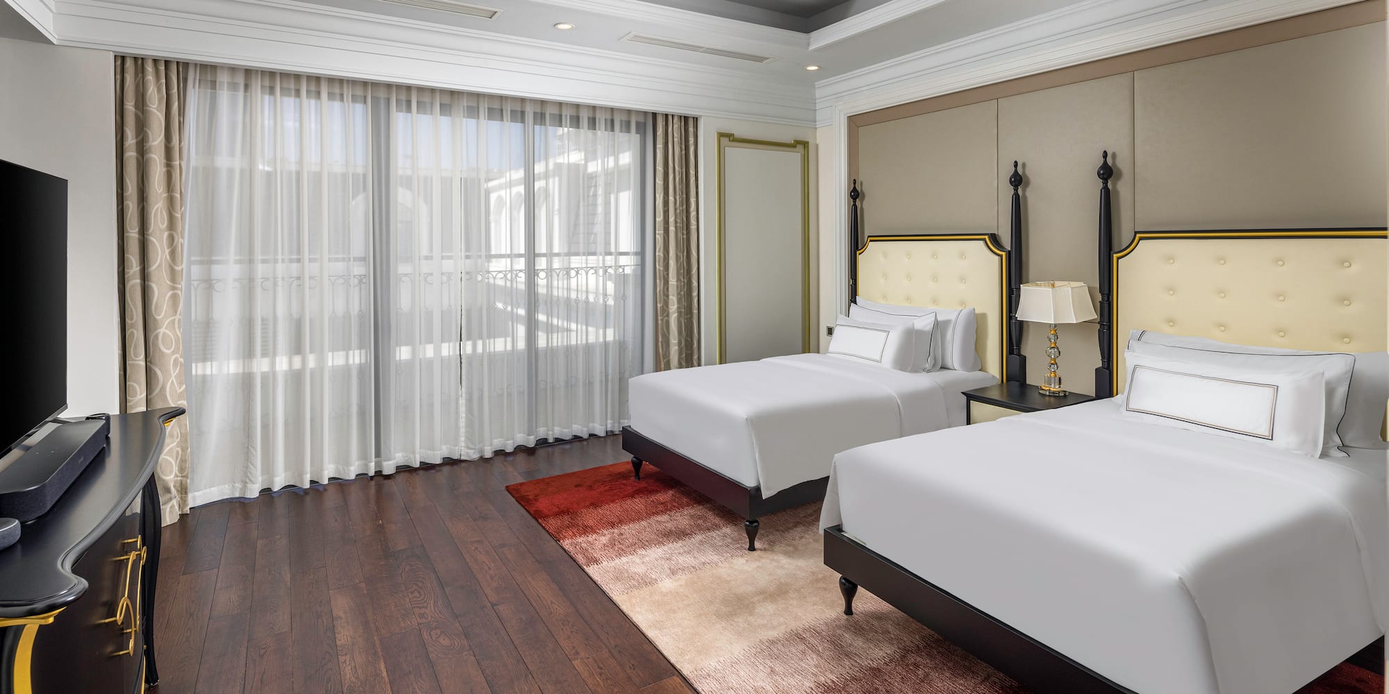 a room with two beds and a ceiling fan