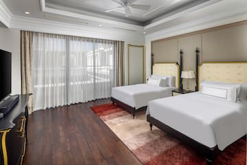 a room with two beds and a ceiling fan