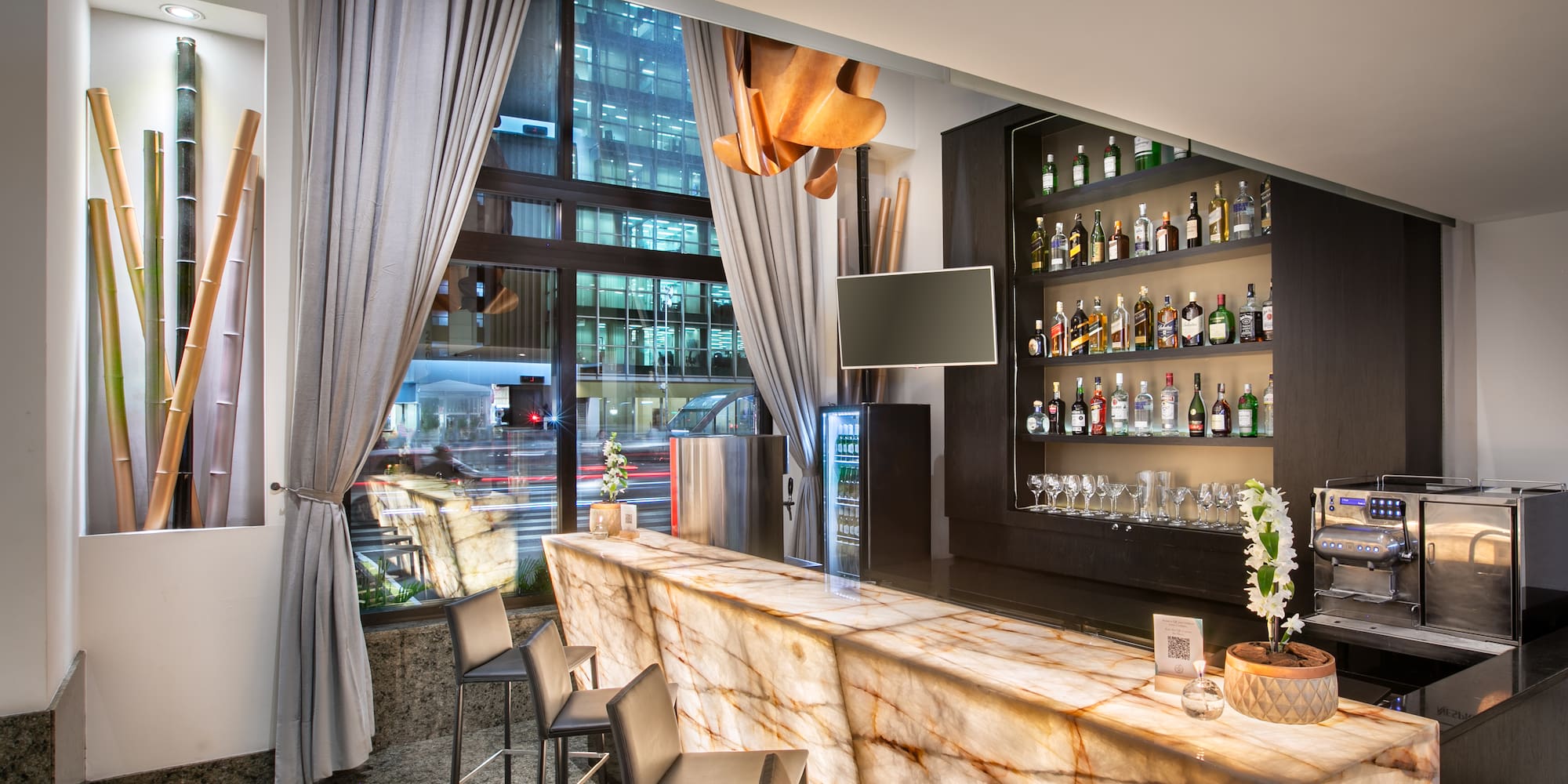 a bar with a counter and chairs