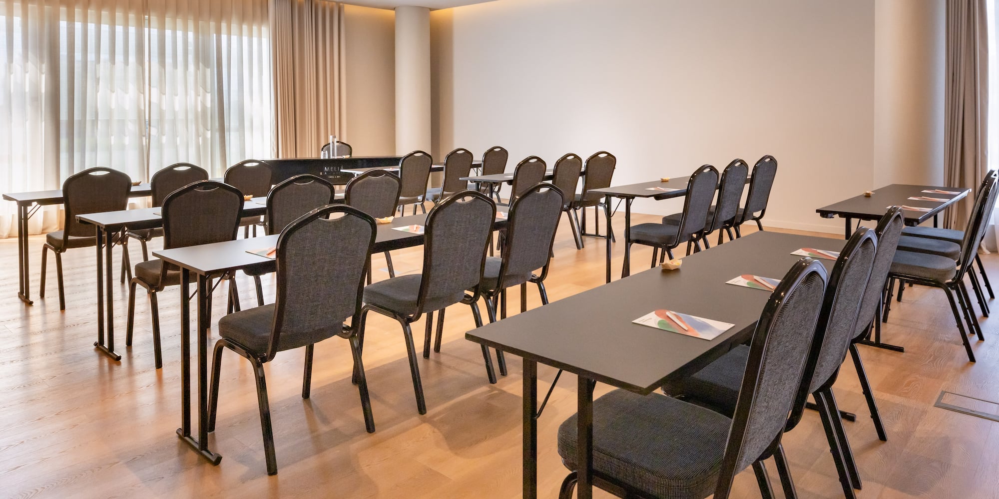 Bright hotel conference room with classroom seating for events.