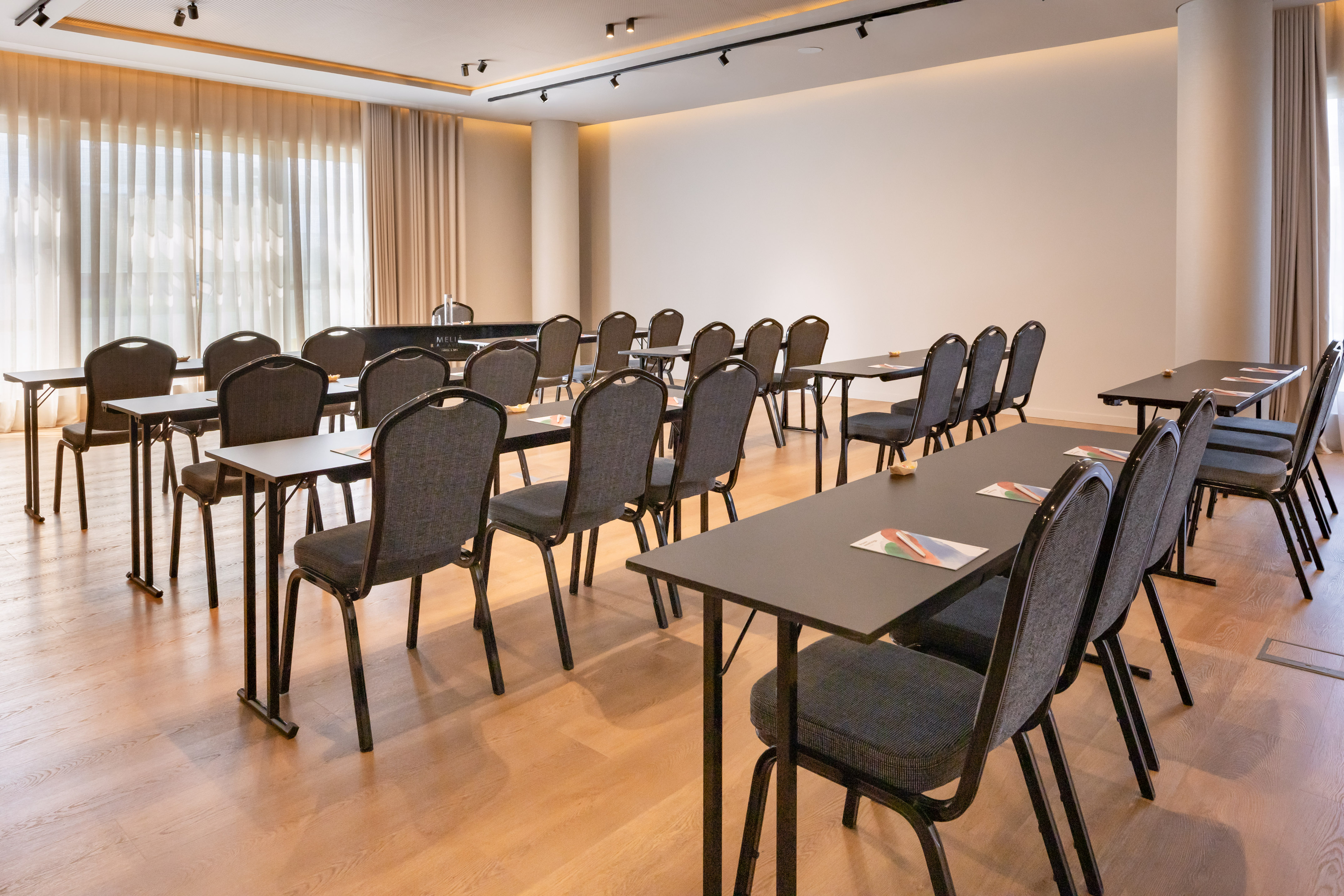 Bright hotel conference room with classroom seating for events.