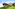 a house with a large lawn and trees