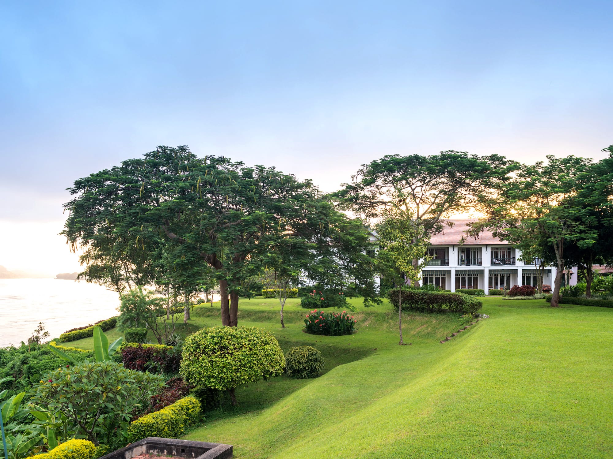 a house with a large lawn and trees