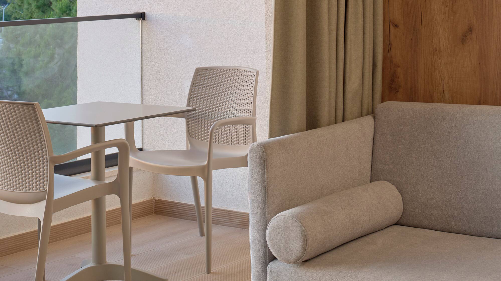 a room with a couch and chairs