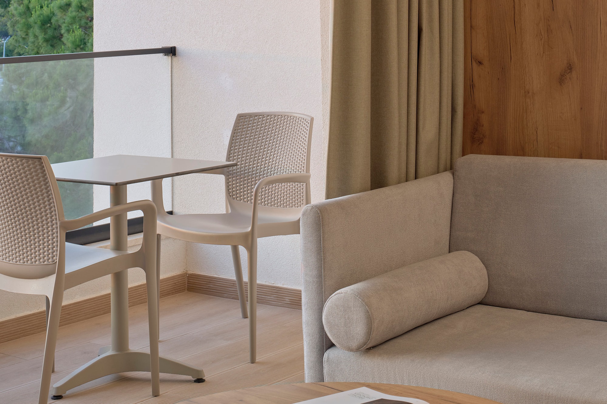 a room with a couch and chairs