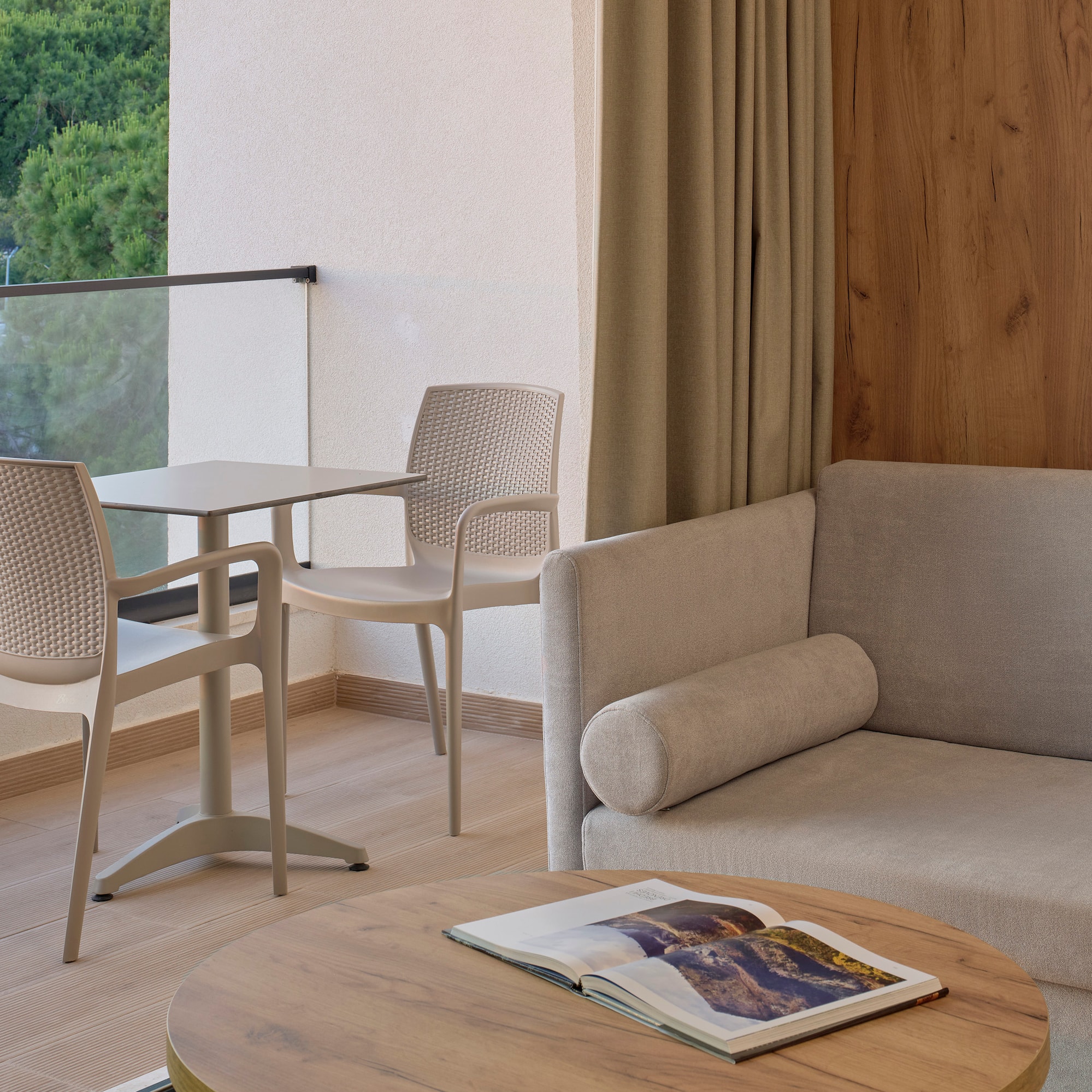 a room with a couch and chairs