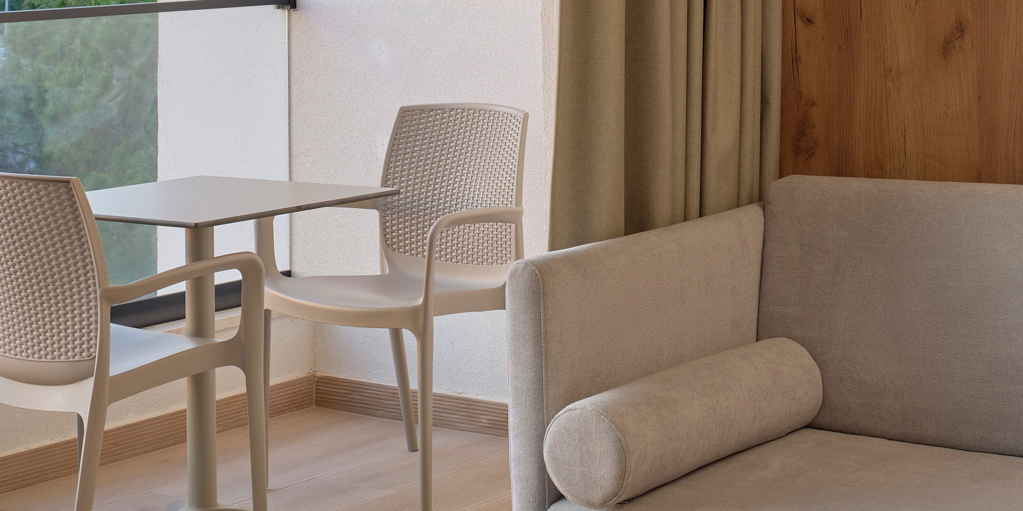 a room with a couch and chairs