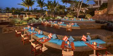 a outdoor seating area with tables and chairs