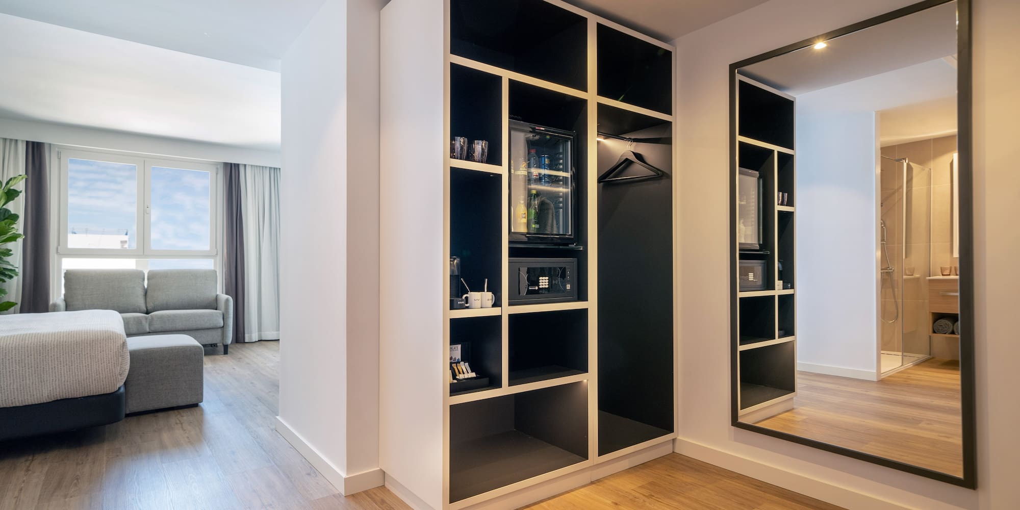 a room with a mirror and shelves