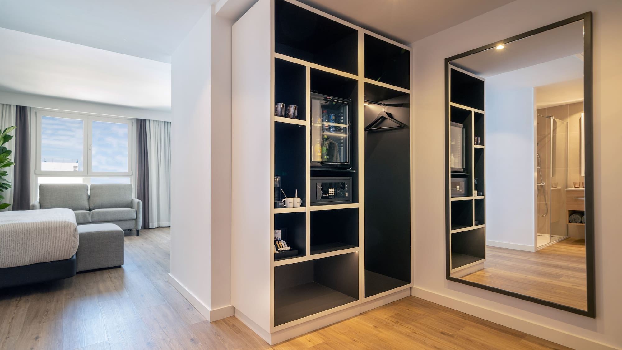 a room with a mirror and shelves