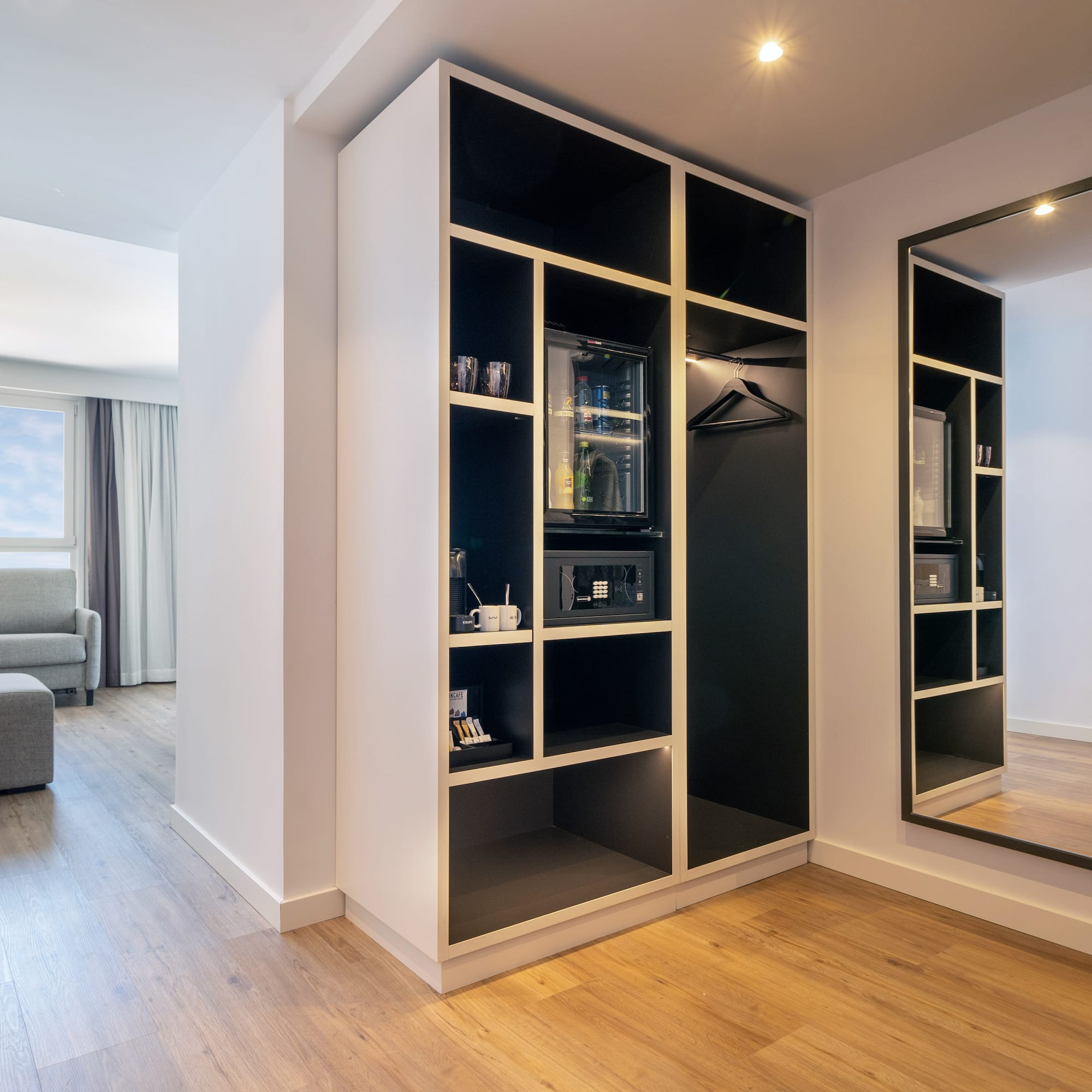 a room with a mirror and shelves