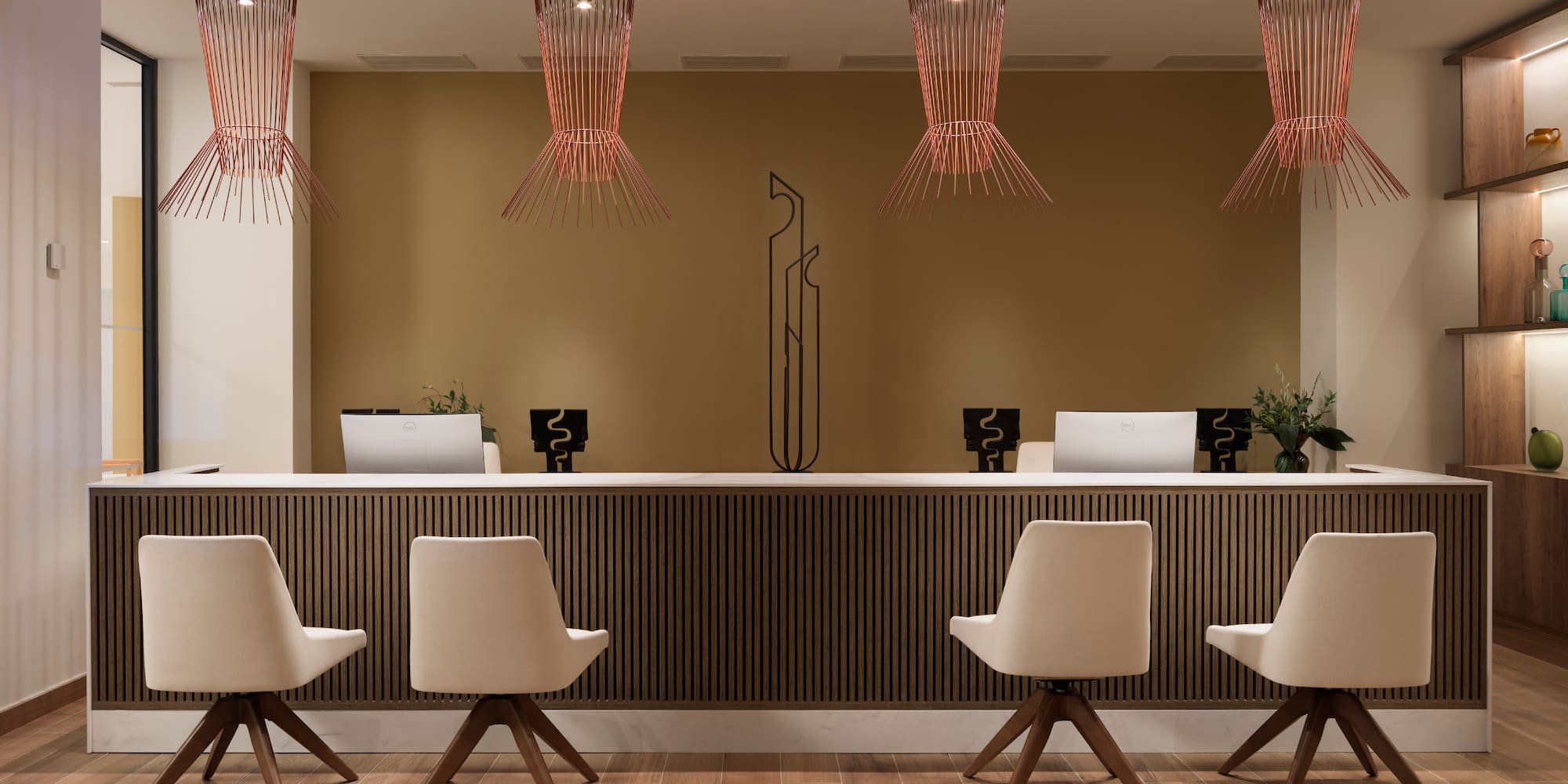 a reception desk with chairs and a chandelier