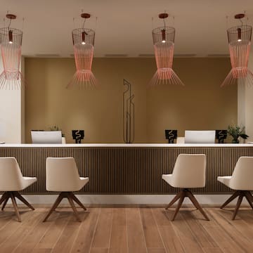 a reception desk with chairs and a chandelier