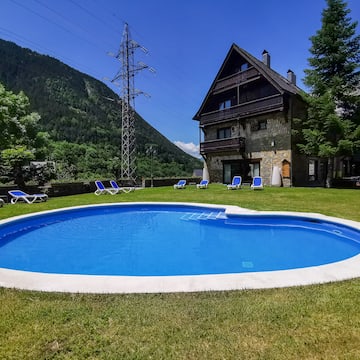 a pool in a backyard with a house in the background