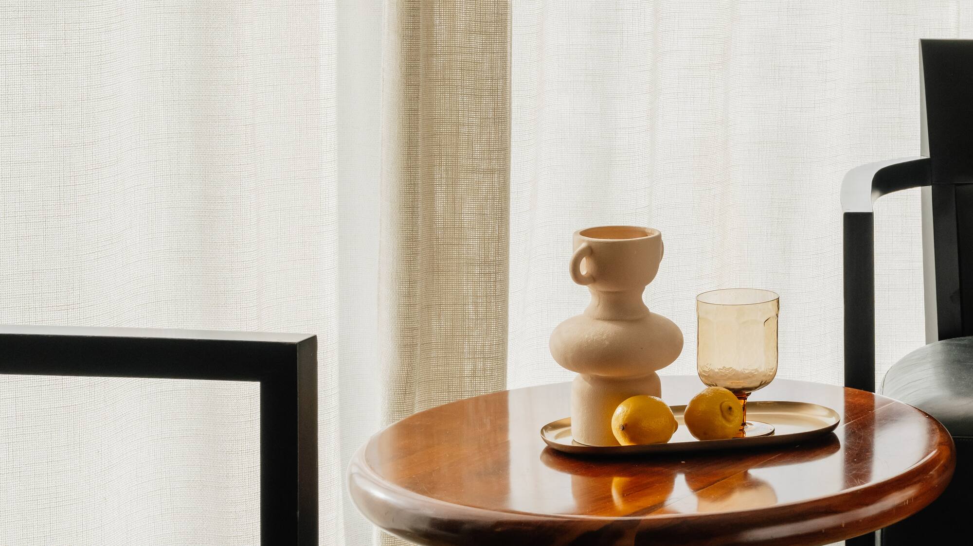 a table with a tray of fruit and a cup on it