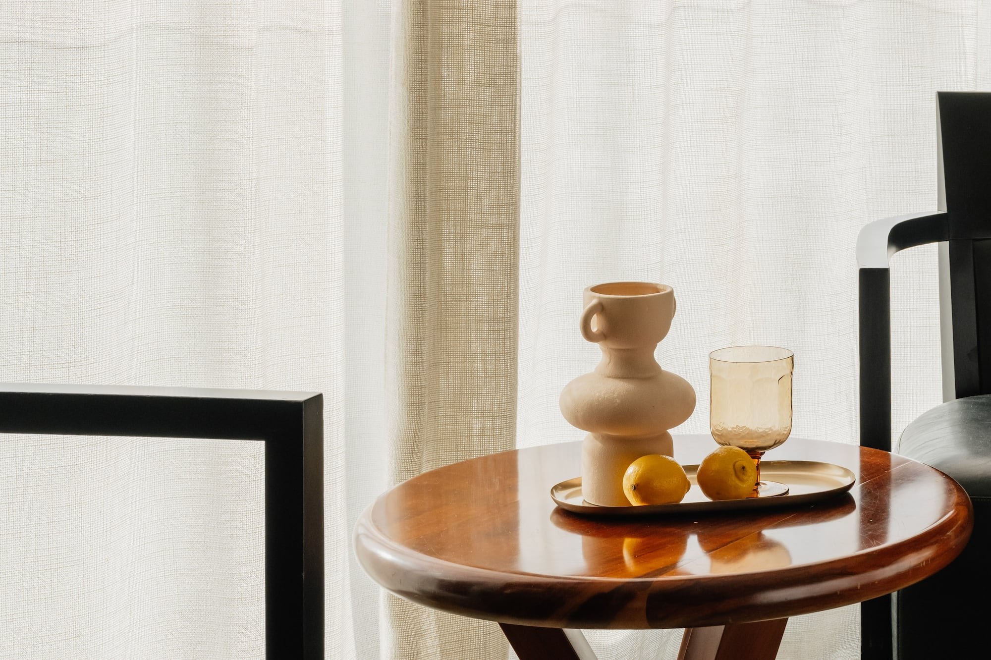 a table with a tray of fruit and a cup on it