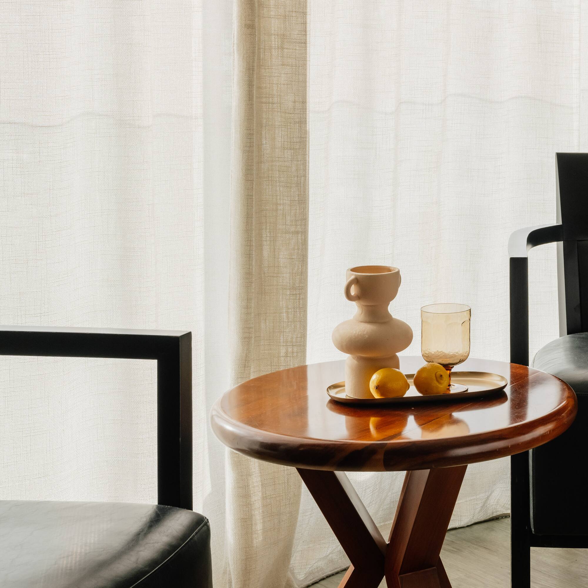 a table with a tray of fruit and a cup on it