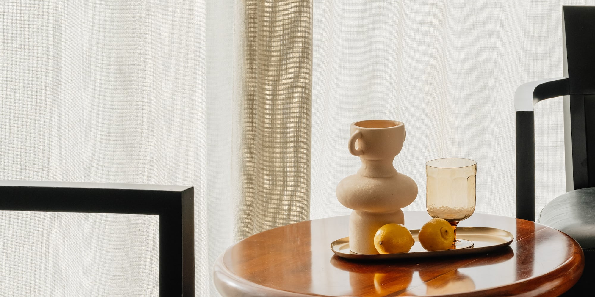 a table with a tray of fruit and a cup on it