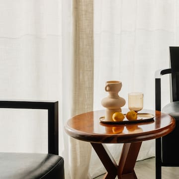 a table with a tray of fruit and a cup on it