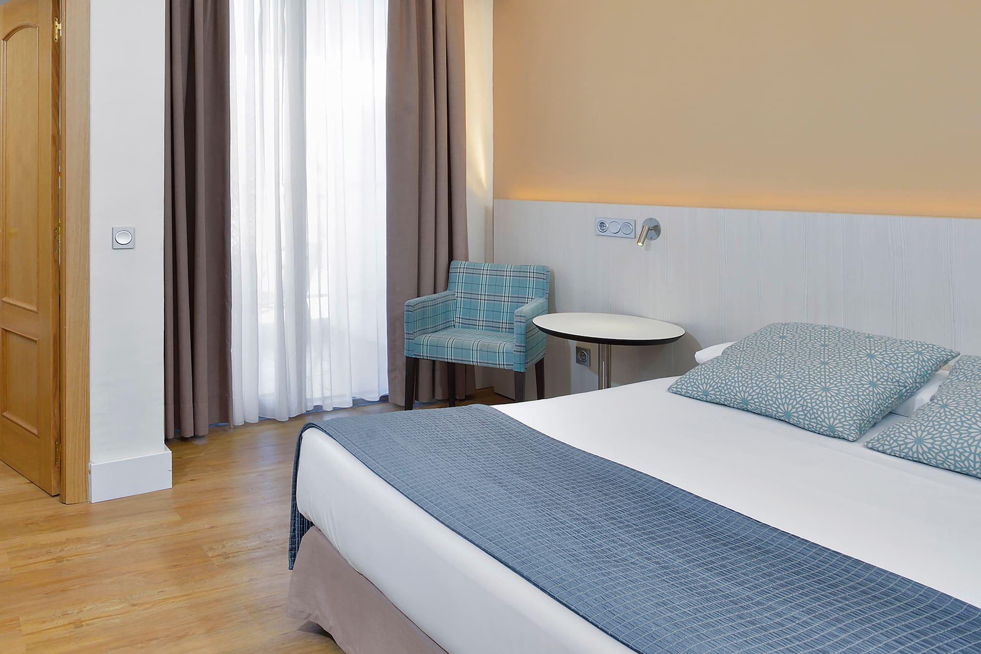 a room with a bed and a chair