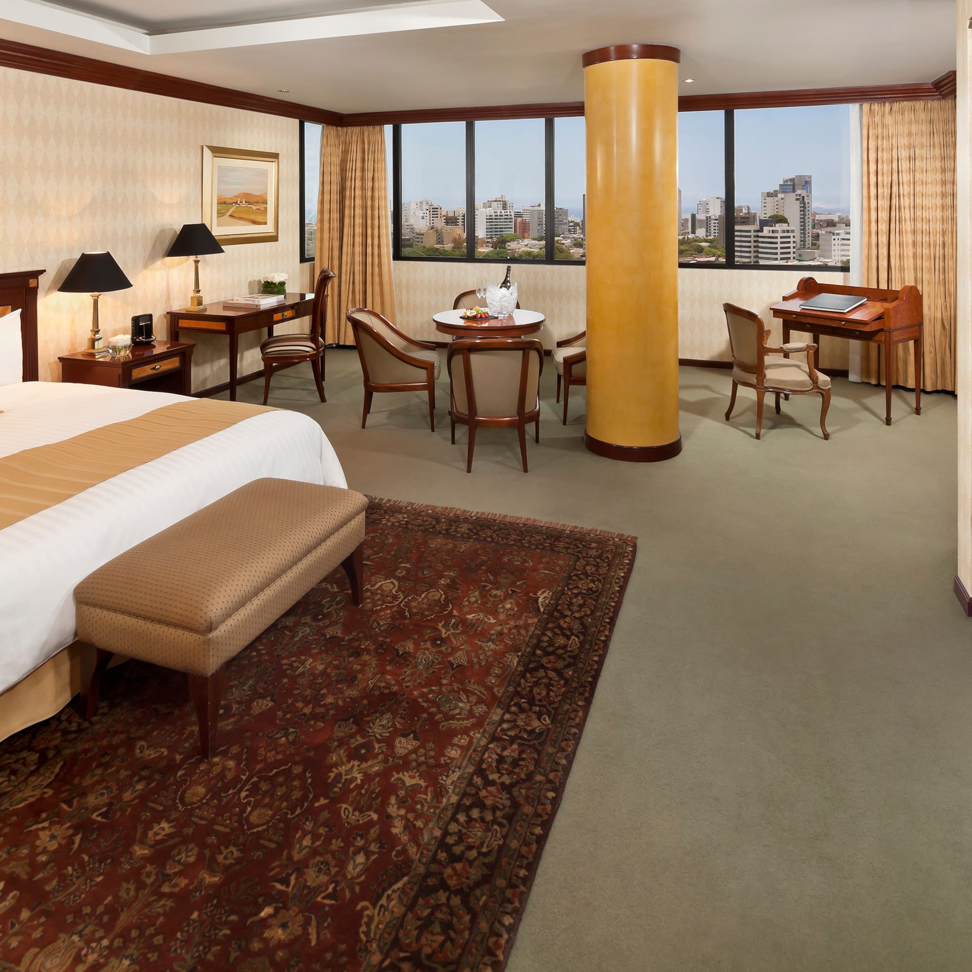 a room with a bed and a table and chairs