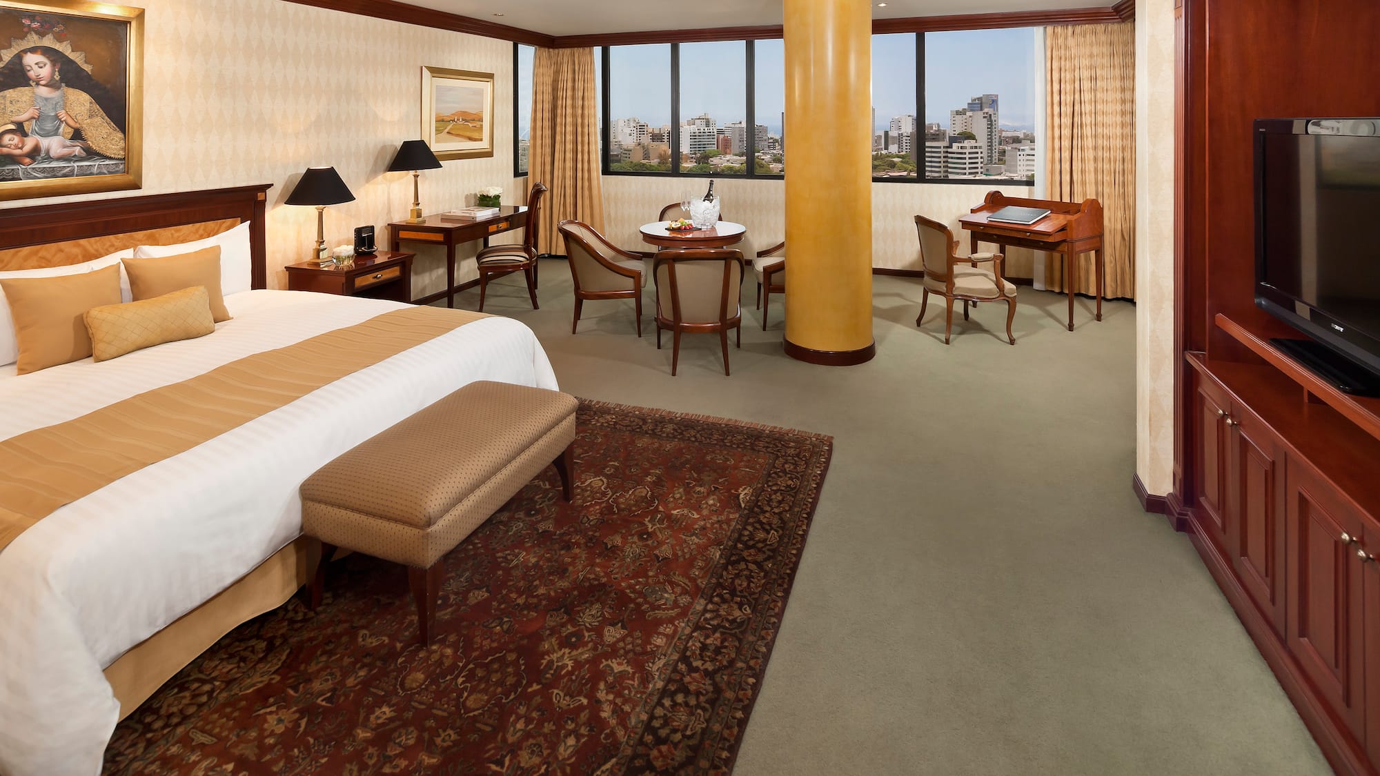 a room with a bed and a table and chairs