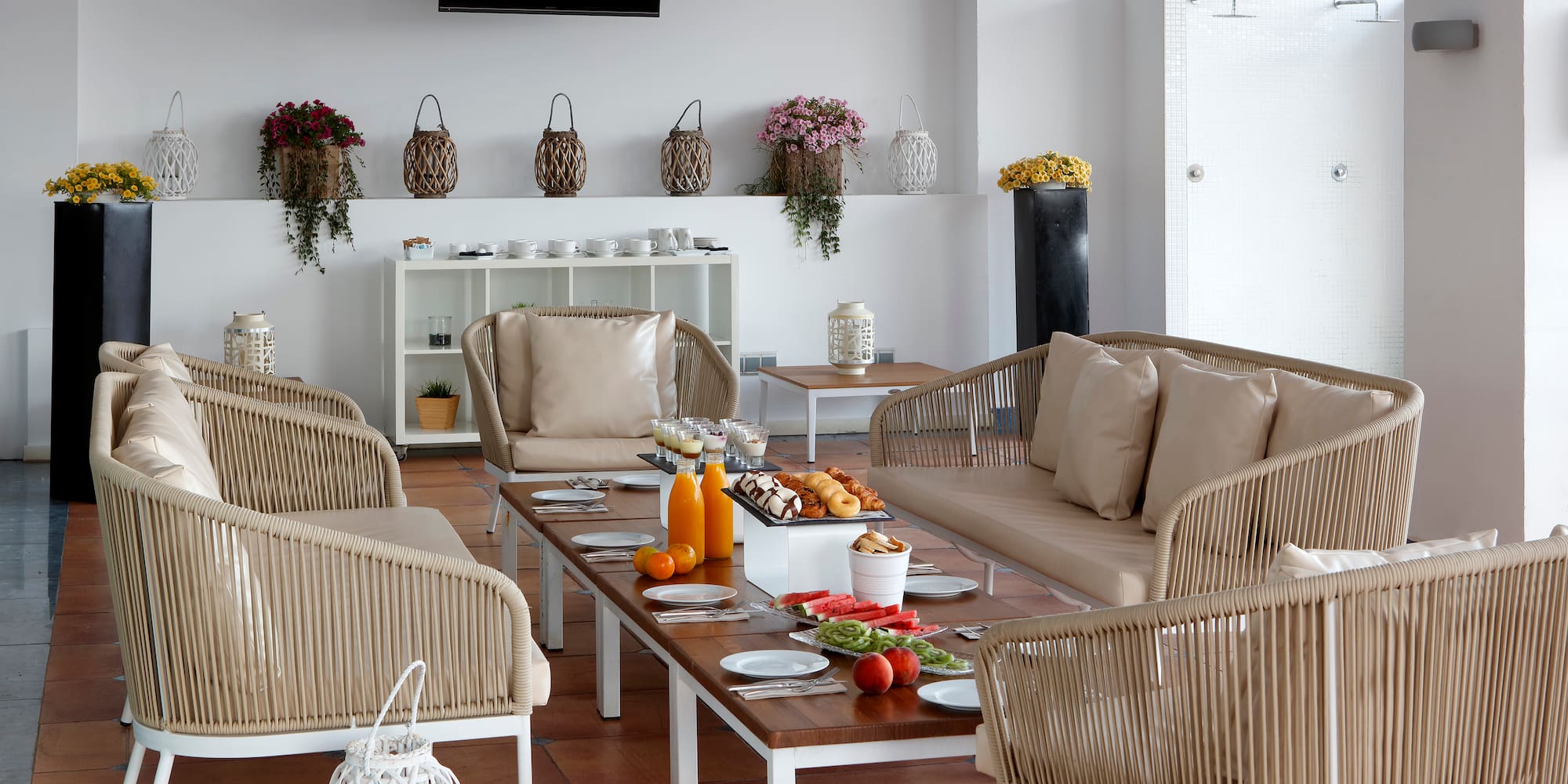 a room with a table of food and chairs