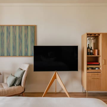 a room with a tv and a shelf