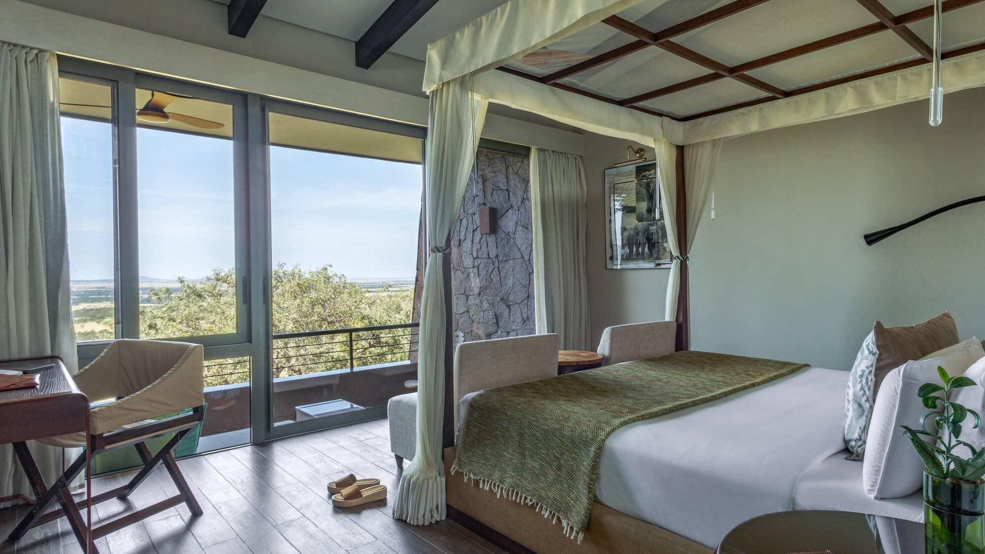 a bedroom with a canopy bed and a chair